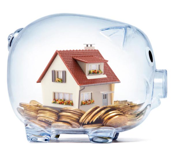 House on money inside transparent piggy bank with clipping path